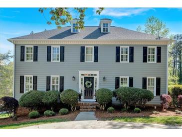 Charming two-story home with a manicured front yard and classic architectural details at 4366 Karls Gate Dr, Marietta, GA 30068