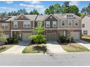 Charming townhouse exterior with well-maintained landscaping and neutral color scheme at 5157 Madeline, Stone Mountain, GA 30083