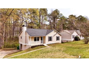 Charming single-story home with a well-maintained front yard and classic architectural details at 6092 Leverett Dr, Lithonia, GA 30038