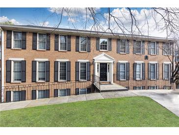 Brick exterior of a multi-story home featuring black shutters and a well-manicured lawn at 1101 Collier Nw Rd # U2, Atlanta, GA 30318