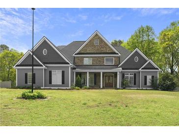 Stately two-story home featuring a combination of gray siding and brick, with a manicured lawn and mature trees at 1350 Blackwell Rd, Marietta, GA 30066