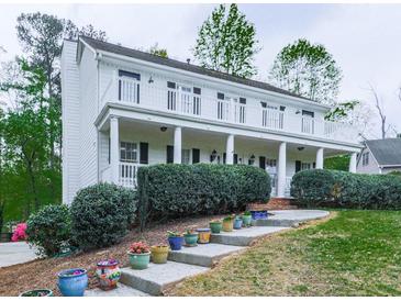 Charming two-story home with a front porch, a second story balcony, and landscaped front yard at 1606 Nuthatch Ct, Marietta, GA 30062