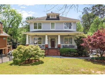 Charming two-story home featuring a welcoming front porch and well-manicured lawn at 1257 Arkwright Se Pl, Atlanta, GA 30317