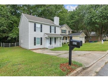 Charming two-story home featuring a classic design, well-maintained lawn, and a welcoming front porch at 425 Orchard Dr, Stone Mountain, GA 30083