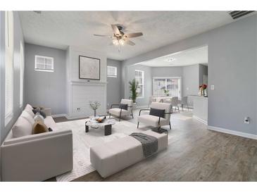 Bright, open living room featuring modern decor, neutral tones, and seamless access to dining area at 4811 Westgate Blvd, Atlanta, GA 30349