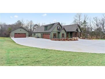 Craftsman home featuring light green siding, dark brown shutters, accent timbers, and a concrete driveway at 510 Price Rd, Carrollton, GA 30116