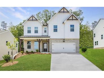 Inviting two-story home showcasing a modern farmhouse design with a pristine lawn and elegant architectural details at 5109 Hillside Haven Dr, Powder Springs, GA 30127