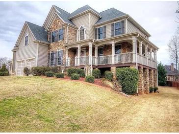 Beautiful two-story home with stone accents, covered porch, and a well-maintained lawn at 5610 Hollowbrooke Ln, Acworth, GA 30101