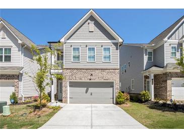 Charming townhouse with a two-car garage and a mix of brick and shingle siding at 3717 Silvery Way, Powder Springs, GA 30127