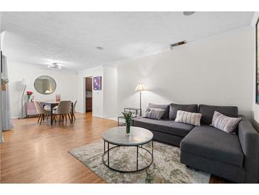 Open-concept living room with wood floors, modern furniture, and neutral decor, perfect for relaxing and entertaining at 1150 Collier Nw Rd # A7, Atlanta, GA 30318