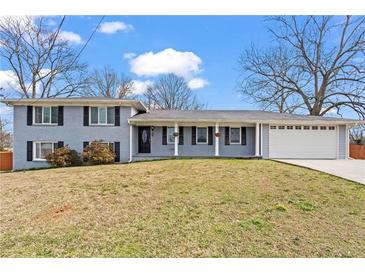 Charming single-story home with blue painted brick and a well-manicured front lawn at 2984 Bayard St, East Point, GA 30344