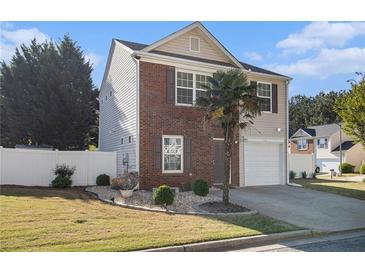 Charming two-story home featuring a brick facade, well-manicured lawn, and a quaint garden at 206 Oak Grove Way, Acworth, GA 30102