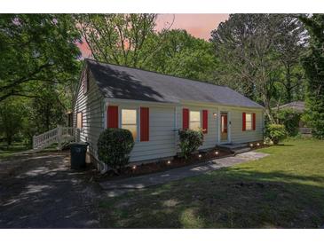 Charming home with red shutters, updated landscaping, and welcoming front entrance at 2488 Glendale Se Cir, Smyrna, GA 30080