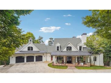 Beautiful exterior of this spacious home with a three car garage and inviting front porch with beautiful stone pillars at 21 Edgewater Se Dr, Cartersville, GA 30121