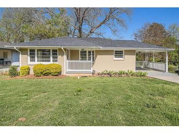 Charming single-story home with brick facade, covered porch, and well-maintained lawn at 1958 Long Dr, Decatur, GA 30032