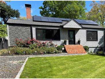 Charming home with solar panels, brick steps, and well-manicured lawn at 727 Channing Nw Dr, Atlanta, GA 30318