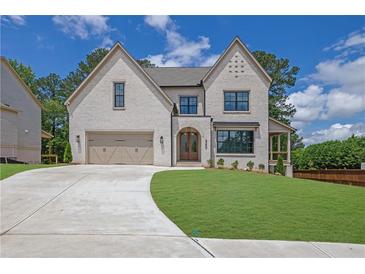 Beautiful two-story home with brick facade, well-manicured lawn, and attached two-car garage at 380 Hillcrest View Dr, Suwanee, GA 30024