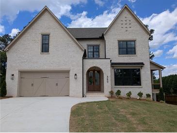 Elegant two-story home features a painted brick exterior and a well-manicured lawn at 380 Hillcrest View Dr, Suwanee, GA 30024