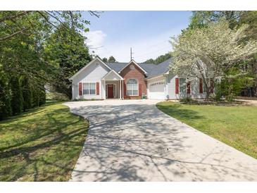 Charming single-Gathering home features a well-manicured lawn and a long driveway at 1635 Round Rd, Grayson, GA 30017