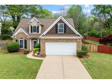 Charming two-story home with brick facade, manicured lawn, and attached two-car garage at 272 William Nye Se Dr, Atlanta, GA 30315