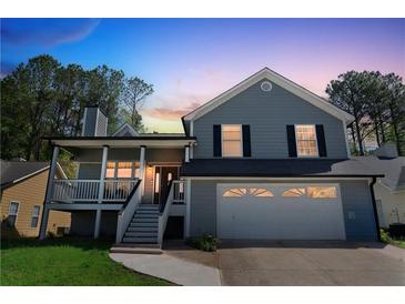 Charming two-story home with a covered front porch and attached two-car garage at 1035 Avalon Dr, Lawrenceville, GA 30044