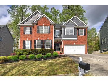 Charming two-story brick home with a manicured lawn and a two-car garage in a desirable neighborhood at 4111 Mcever Woods Nw Dr, Acworth, GA 30101