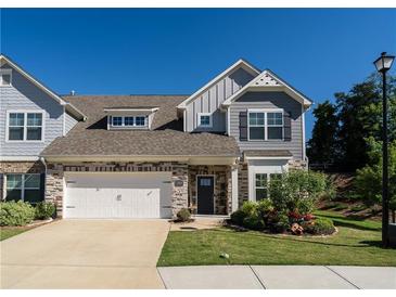 Charming two-story home with stone accents, neutral siding, and a well-maintained lawn, complemented by a two-car garage at 1809 Park Land Ln, Snellville, GA 30078