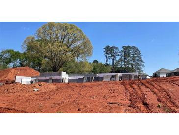 New home foundation under construction with soil backdrop against a blue sky at 3063 Reserve Ct Sw, Conyers, GA 30094