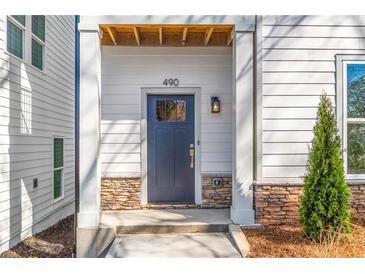 Inviting front entrance with stone accents and a stylish dark-colored door and a hanging lantern at 490 Hammons Way, Atlanta, GA 30315