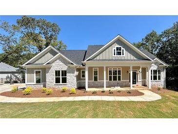 Charming single-Gathering home with stone accents, covered porch, and freshly landscaped front yard at 31 Cedar Gate Ln, Kingston, GA 30145