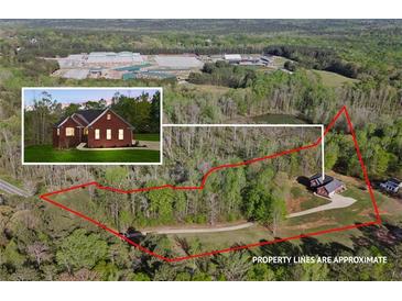 Expansive aerial view of property with generous acreage, mature trees, and pond at 896 Winn Rd, Douglasville, GA 30134