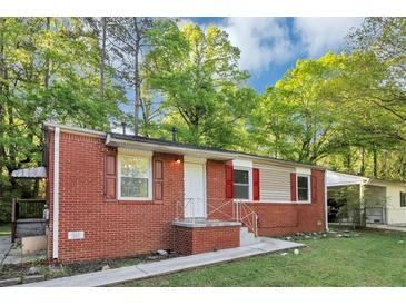 Charming brick home featuring red shutters and a well-maintained front yard at 299 Ard Nw Pl, Atlanta, GA 30331