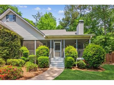 Charming home with a screened-in porch and well-maintained landscaping at 7675 Rose Ln, Cumming, GA 30040