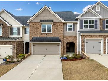Charming brick townhome with a one-car garage and well-maintained landscaping at 1307 Park Center Cir, Austell, GA 30168