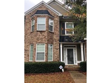 Charming brick two-story home featuring manicured landscaping and inviting front porch at 5449 Festival Ave, Fairburn, GA 30213