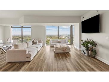 Bright living room featuring floor-to-ceiling windows with city views and contemporary furnishings at 270 17Th Nw St # 3604, Atlanta, GA 30363