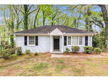 Charming single-story home with a brick facade, black shutters, and well-maintained landscaping at 2168 Doris Dr, Decatur, GA 30034