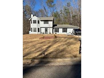 Charming two-story home featuring a well-maintained lawn and complemented by mature trees at 3833 Brookstone Way, Ellenwood, GA 30294
