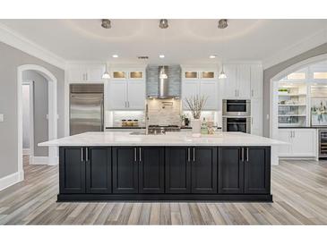 Spacious kitchen with a large island, stainless steel appliances, and lots of cabinet space at 2444 Ballantrae Cir, Cumming, GA 30041