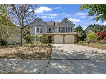 Charming two-story home featuring a stone facade, two-car garage, and well-maintained landscaping at 35 Kestrel Circle, Covington, GA 30014