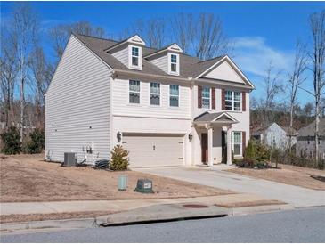 Charming two-story home with gray siding, brick accents and a two-car garage at 5460 Wheeler Ridge Rd, Auburn, GA 30011