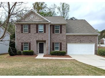 Charming two-story brick home with attached garage and well-maintained landscaping at 3005 Stonebrook Cv, Austell, GA 30106
