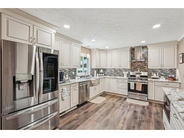 Modern kitchen with stainless steel appliances, granite countertops, and custom cabinetry at 1522 Sprayberry Dr, Marietta, GA 30066