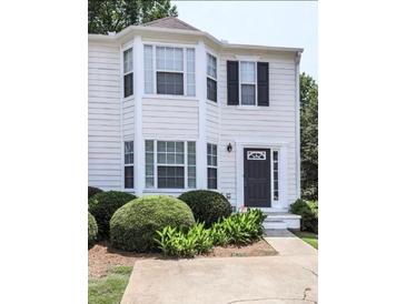 Charming townhouse featuring a well-maintained lawn, beautiful landscaping, and a welcoming front entrance at 4420 Thorngate Ln, Acworth, GA 30101