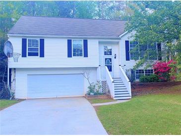 Charming split-level home featuring a two-car garage, classic white siding, and well-maintained landscaping at 4443 Whitt Mill Nw Rd, Acworth, GA 30101