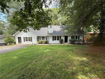 Charming single-story home with a well-maintained lawn and mature trees at 3013 Barcelona Way, Conyers, GA 30012