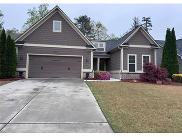 Charming single-story home with a two-car garage, manicured lawn, and colorful landscaping at 3622 Foxtrot Nw Trl, Kennesaw, GA 30144