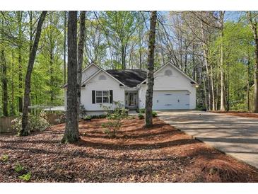 Charming single-Gathering home with a well-manicured lawn, two-car garage and beautiful, mature landscaping at 5845 Shannon Dr, Cumming, GA 30040