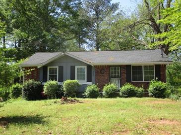 Charming single-story home with a well-maintained front lawn and mature trees at 8317 Marlborough Dr, Jonesboro, GA 30238