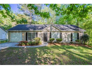 Charming single-story home featuring manicured landscaping, inviting curb appeal, and a one-car garage at 2800 Macon Se Dr, Atlanta, GA 30354